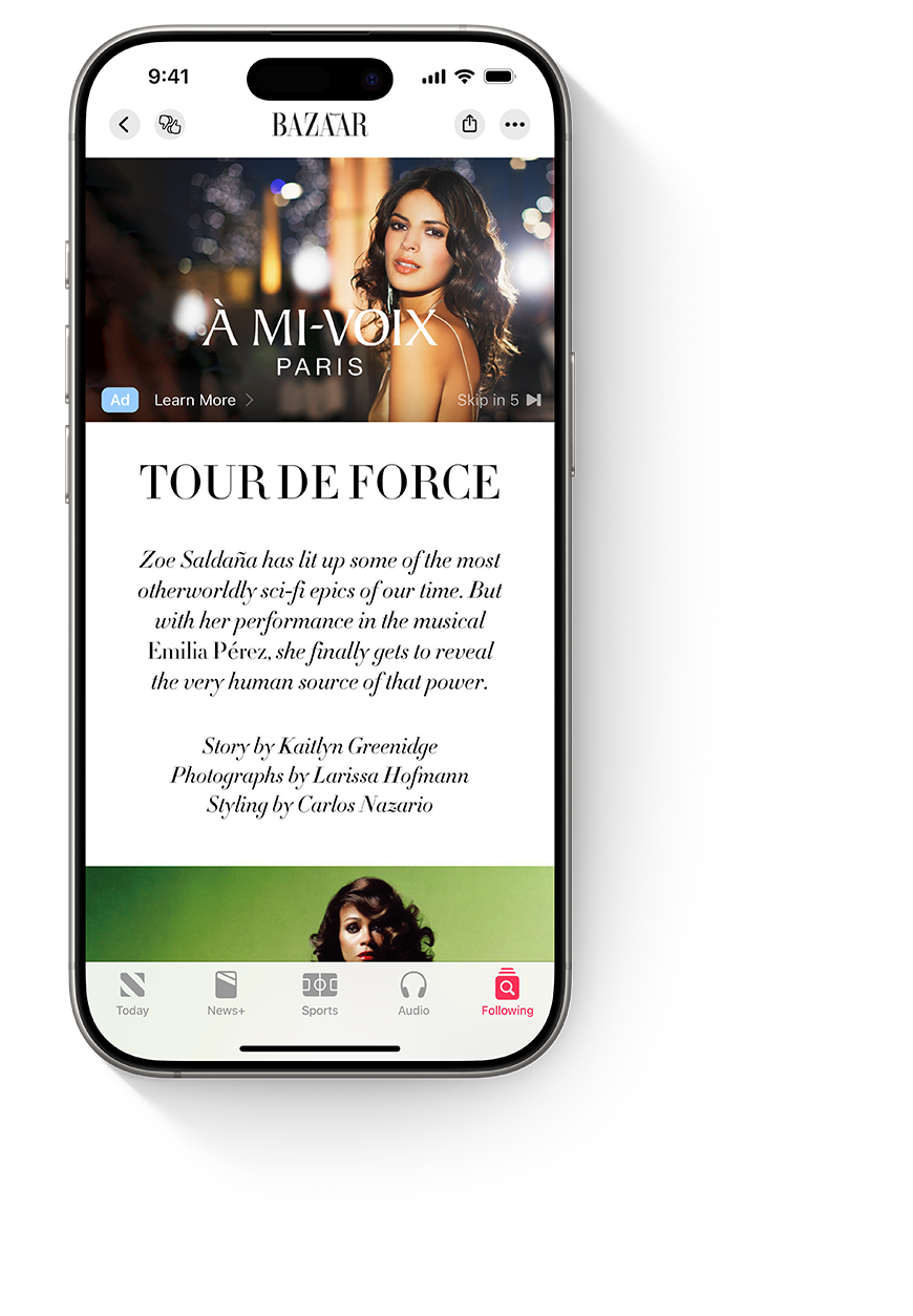 An iPhone with the Apple News app open, showing a video ad for the example couture brand Á Mi-Voix above a Hollywood Reporter article about red carpet clothes.